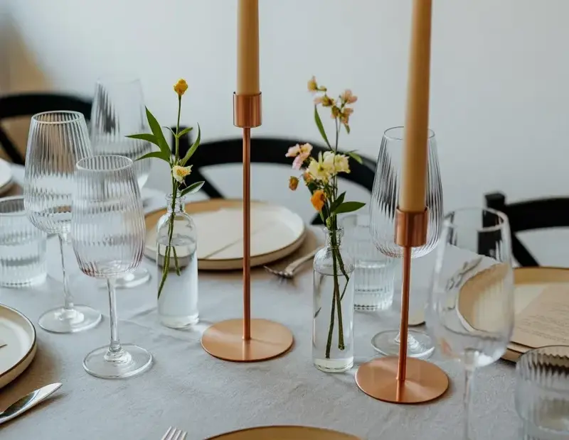 From Plain to Pretty: Minimalist Table Setting with Copper Candlesticks and Flowers