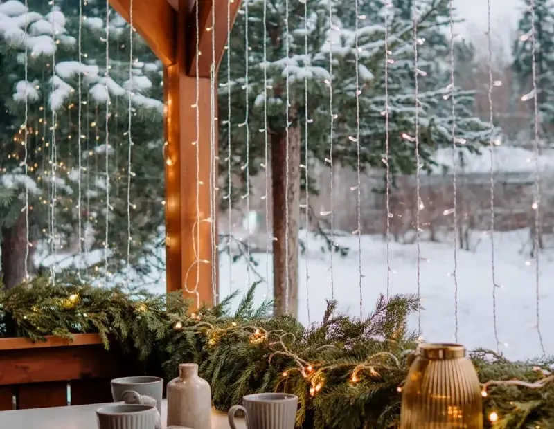 Cozy Winter Porch Makeover Before & After - String Lights & Evergreen Garland